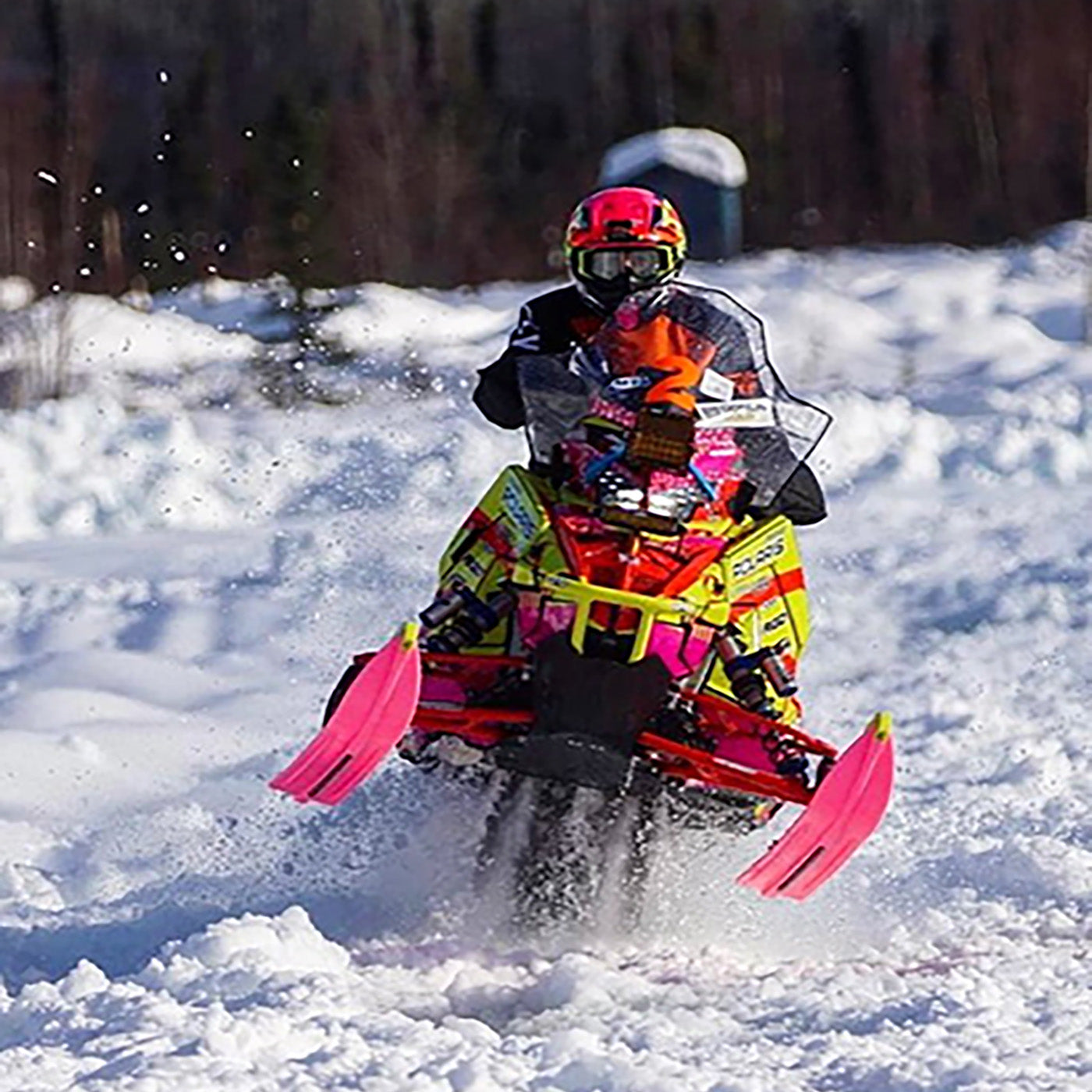 Pro Snowmobile Racer Leah Bauer using pink C&A Pro skis with yellow handles on her sled during a race. 