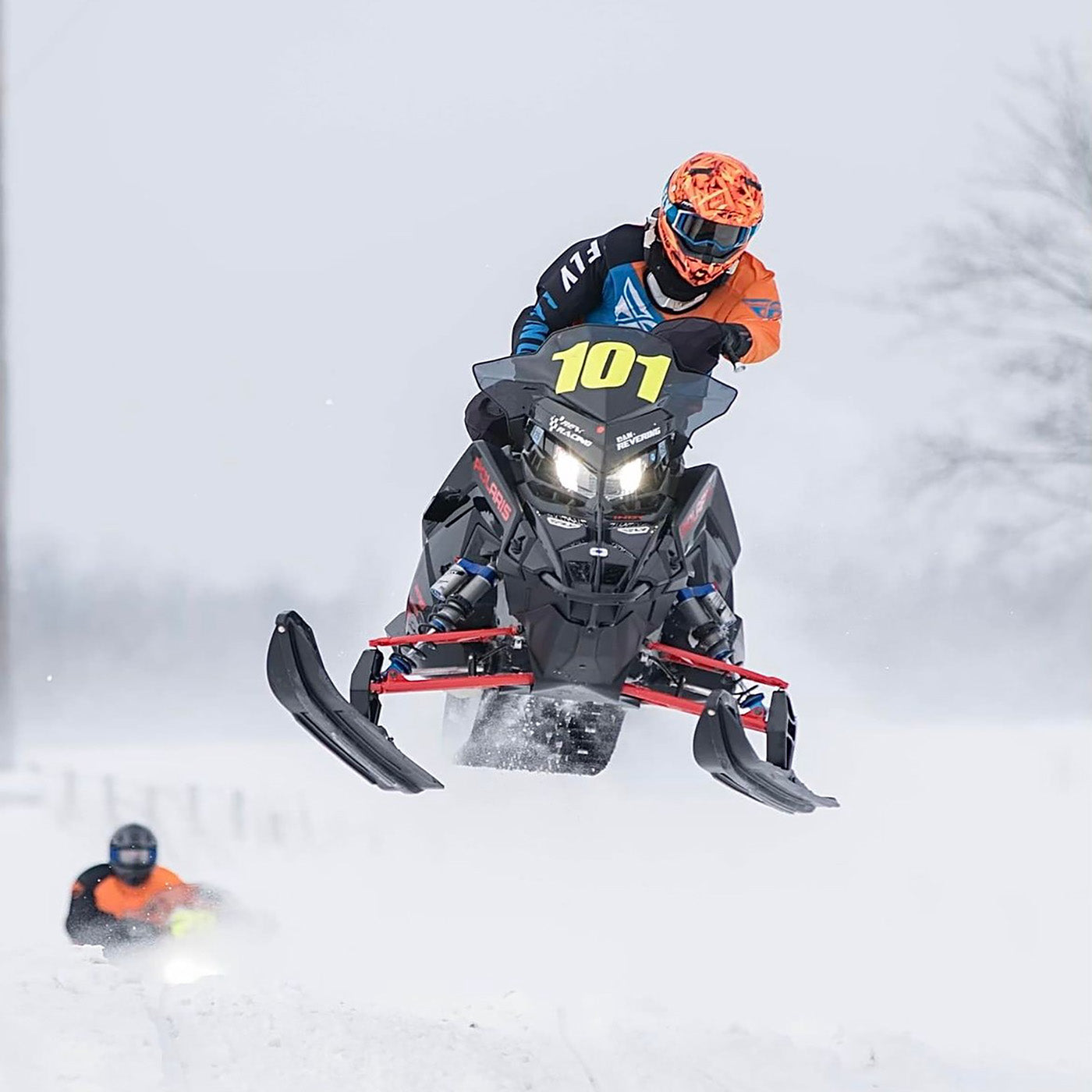 #101 Dan Revering passing Justin Tate in a 2023 race using all-black C&A Pro skis.