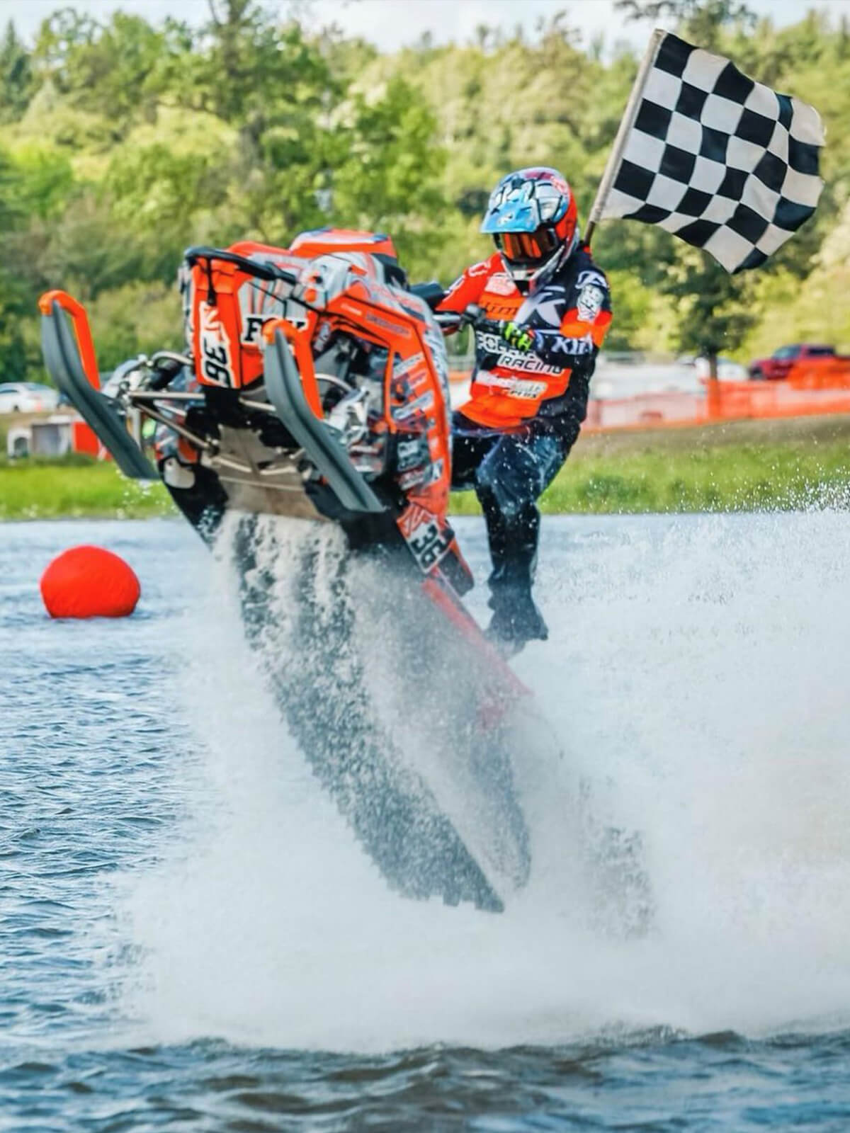 Professional watercross racer #36 David Fischer riding Polaris snowmobile on the water at International Watercross Association event