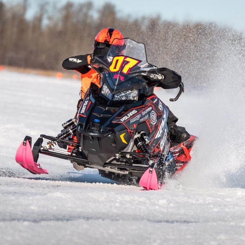 Cross country snowmobile racer Leah Bauer with pink XPT trails skis from C&A Pro Skis.