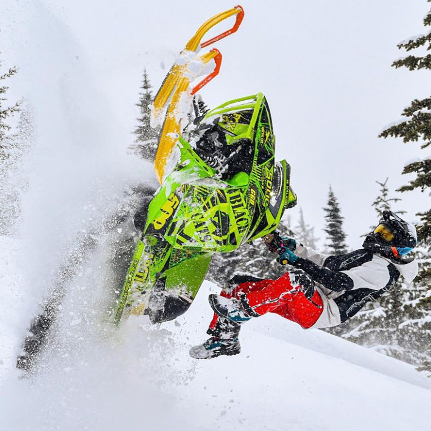 Maverick Walker snowmobiling with yellow C&A Pro skis with orange handles 