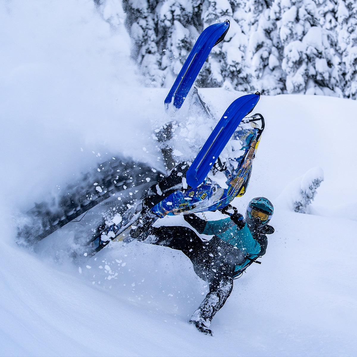 Backcountry professional rider Scott Eyer doing a backcountry trick on a snowmobile with C&A Pro BX mountain skis