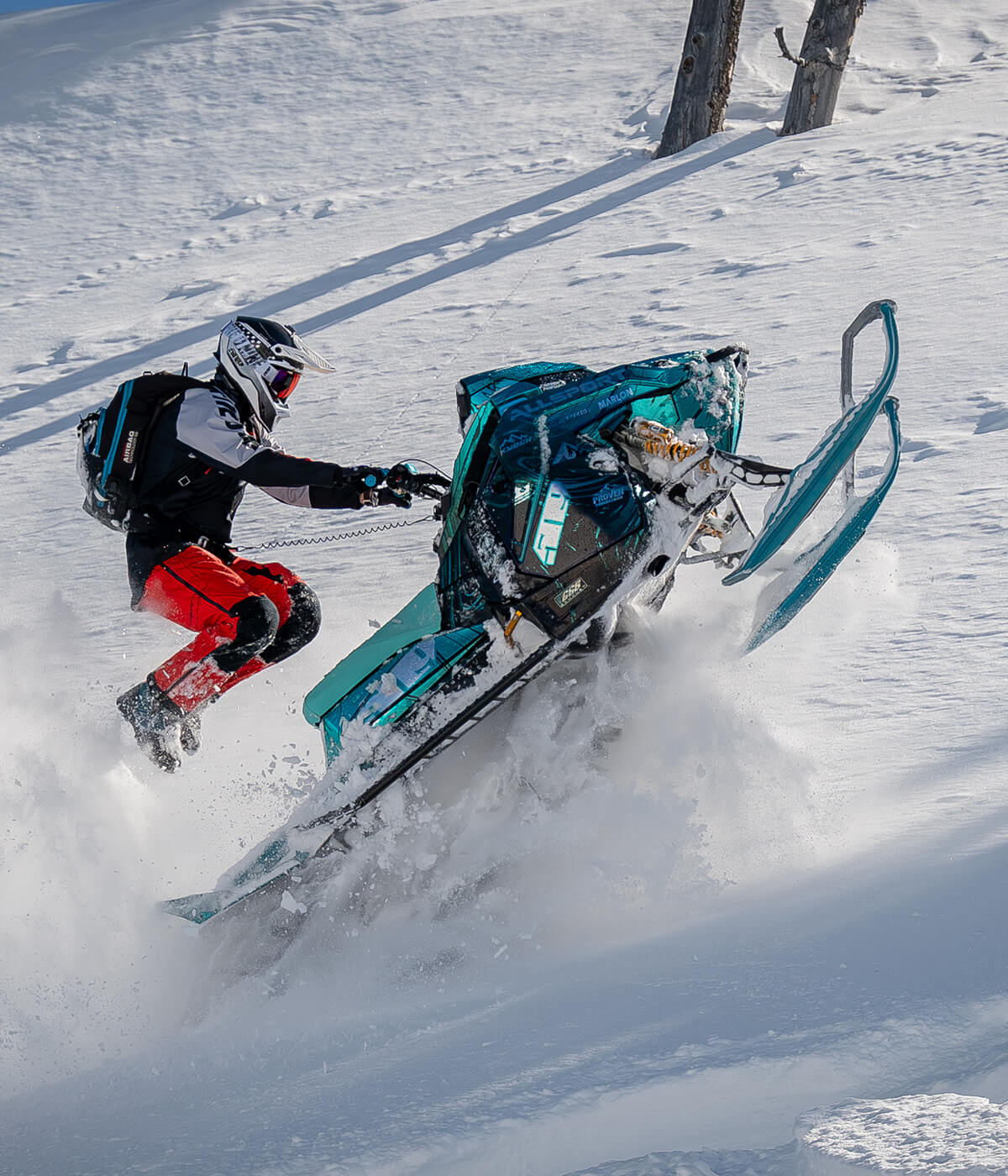 C&A Pro backcountry rider Scott Eyer hopping over snowmobile with Sky Blue TMX skis