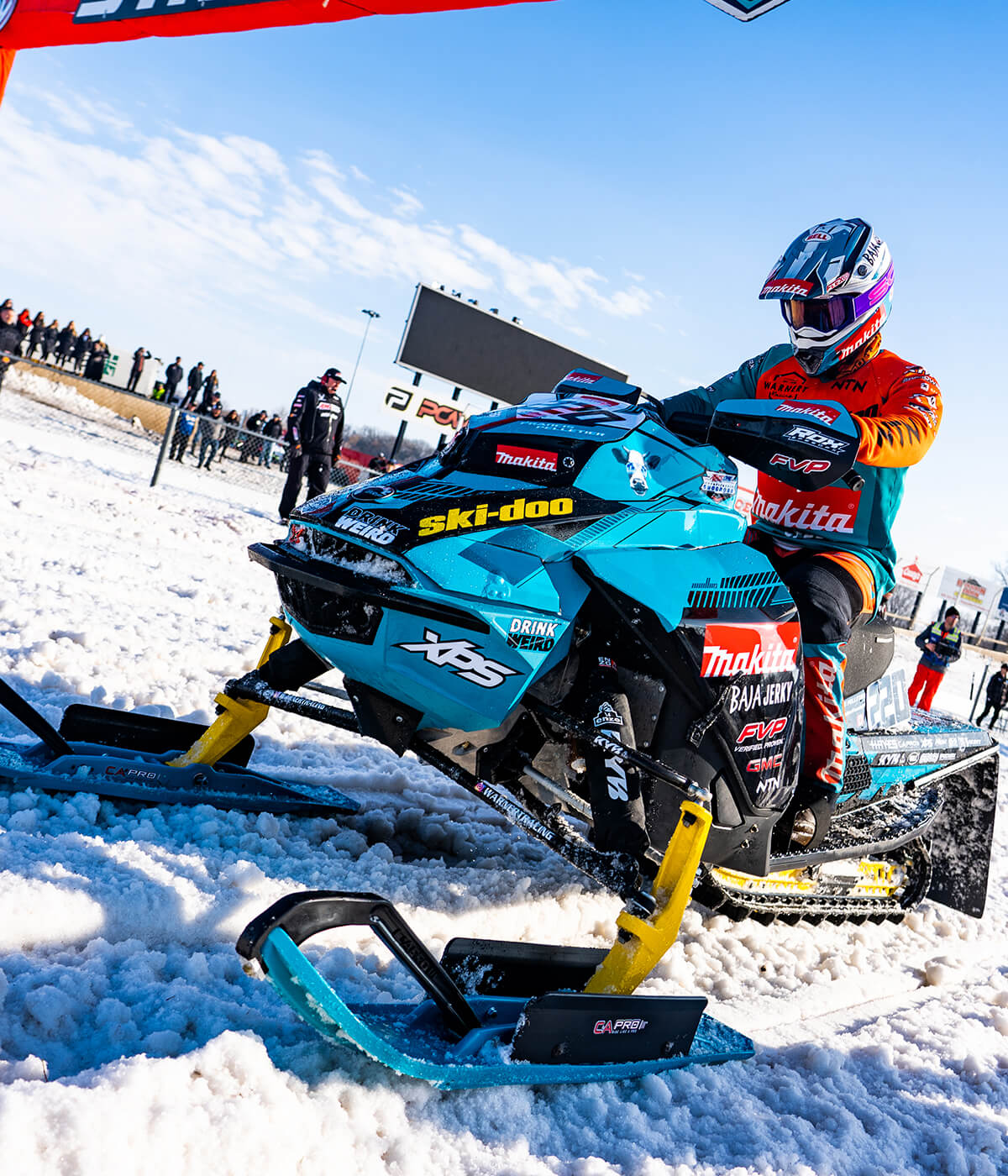 Professional Snocross racer on Ski-Doo snowmobile with custom Sky Blue C&A Pro XT skis and black C&A Pro cornering kits