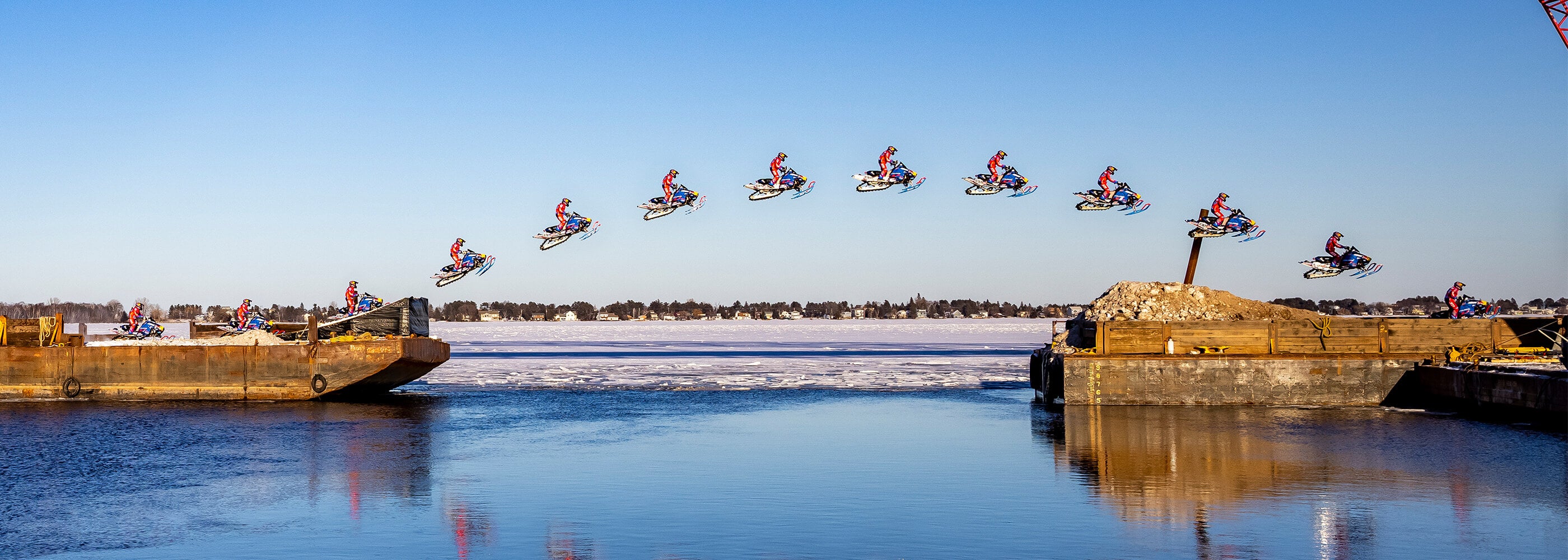 Professional freestyle snowmobile athlete Levi LaVallee jumps over canal in Duluth, Minnesota