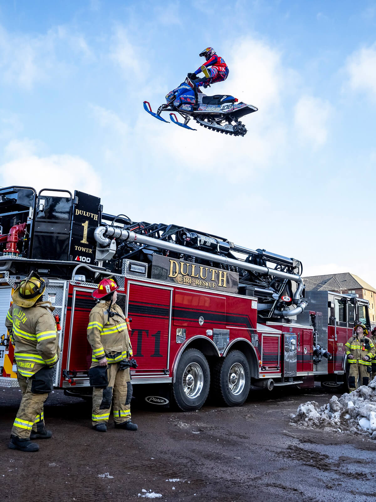 Professional freestyle snowmobile athlete Levi LaVallee jumps over a fire truck in Duluth, Minnesota with C&A Pro RZ skis