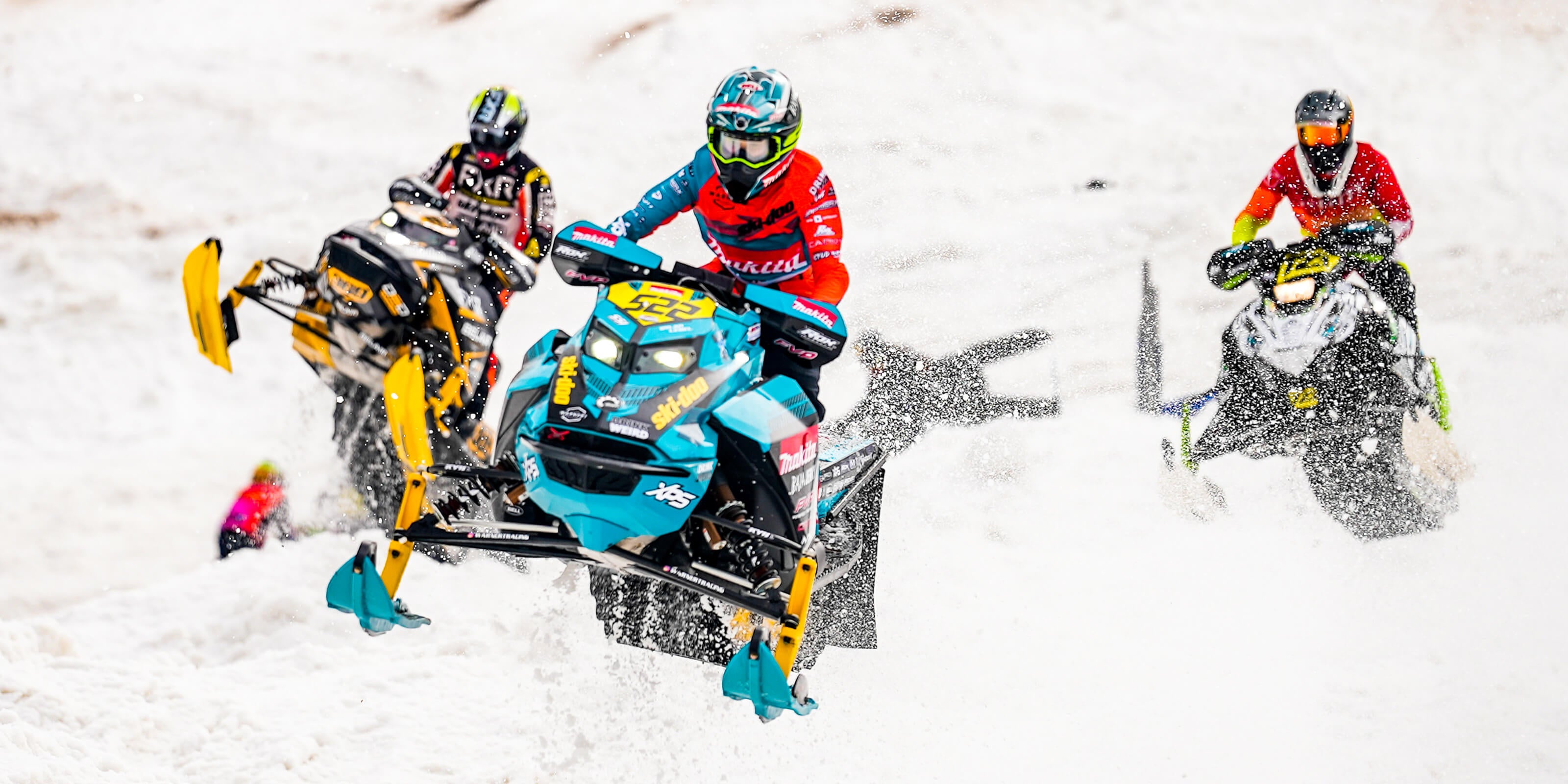Front view of three racers sledding