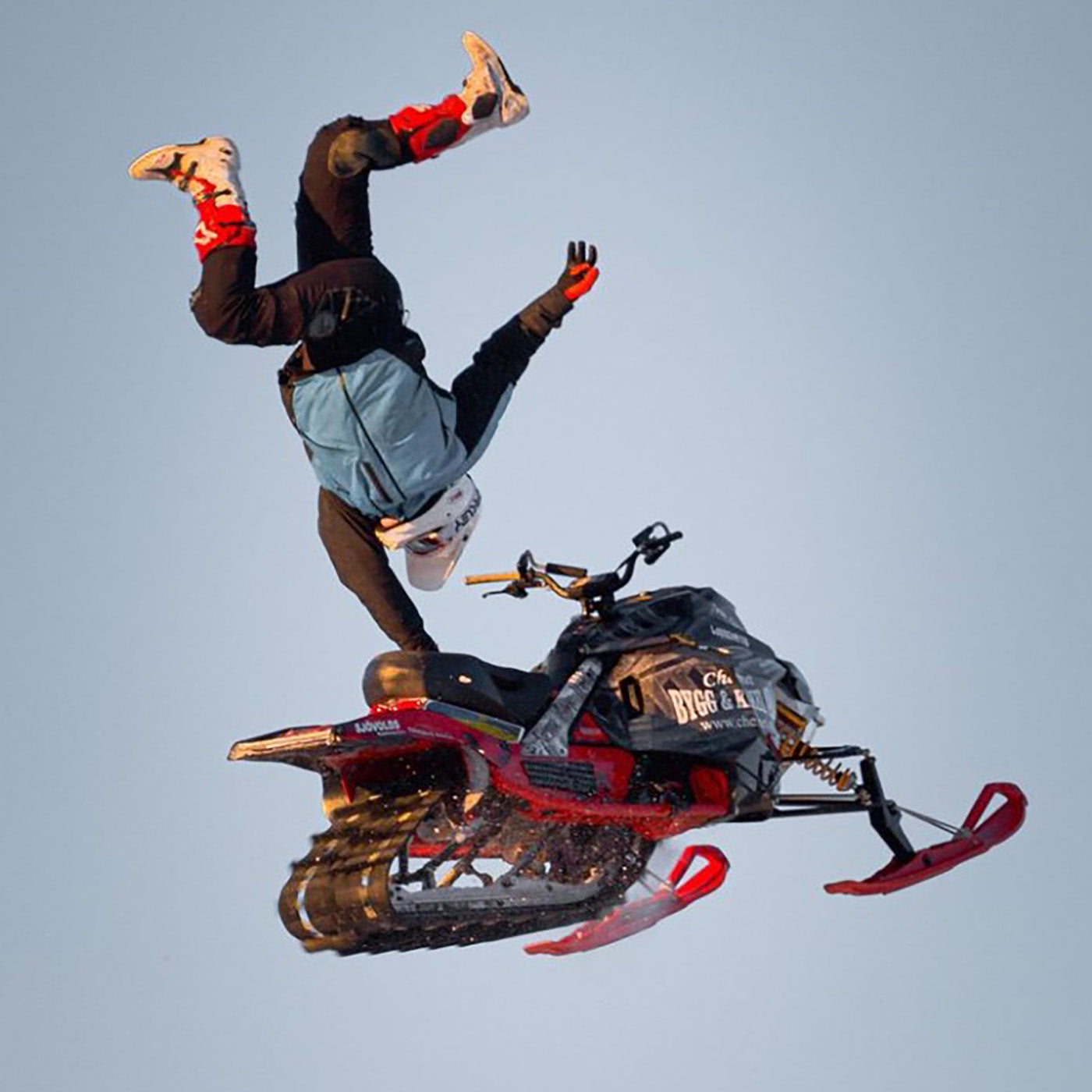 Marcus Ohlsson midair on sled with all-red C&A Pro skis