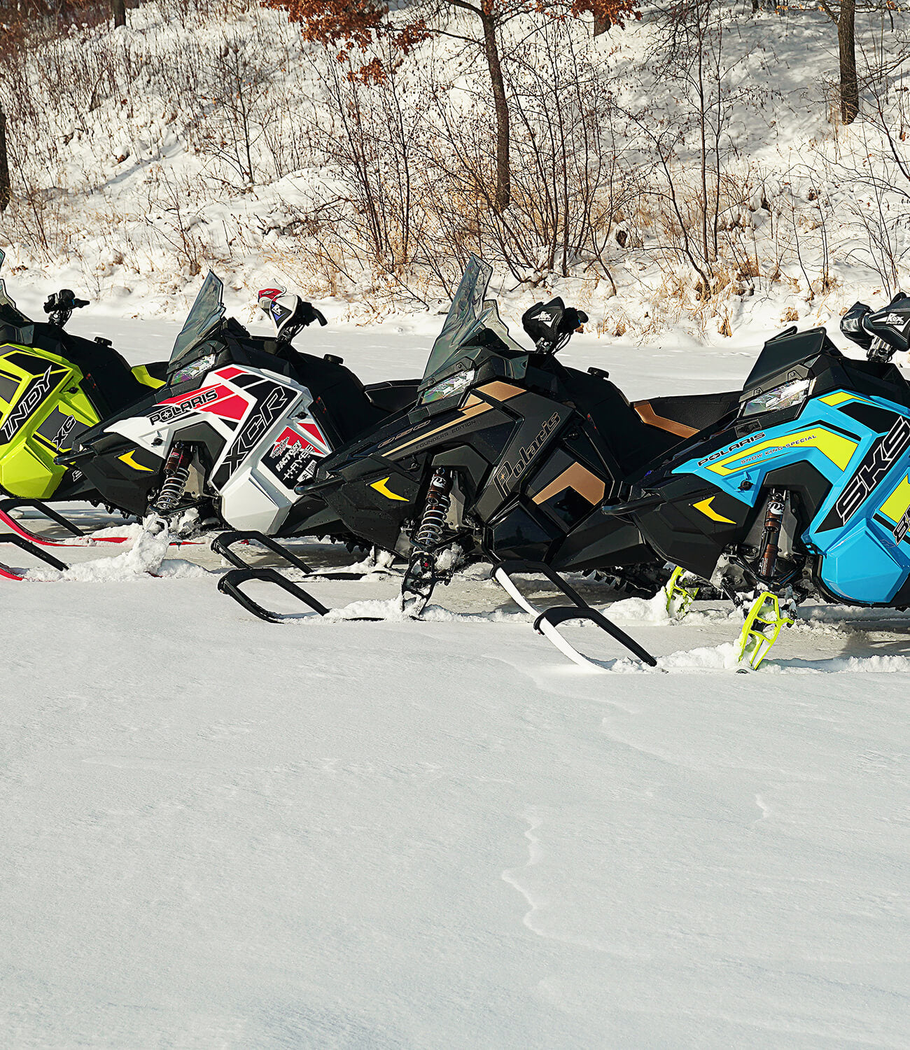 Polaris snowmobiles on a snowy trail equipped with C&A Pro Snowmobile Skis for trail riding.