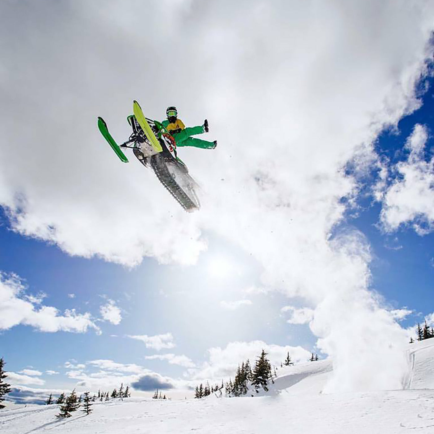Brett Turcotte midair with a green and a lime green pair of C&A Pro skis with black handles